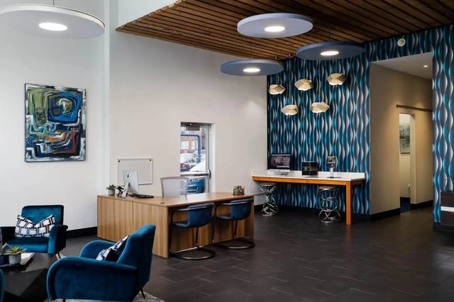 Reception desk chairs painting abstract artwork interior at The Lex in Lexington Student Accommodation