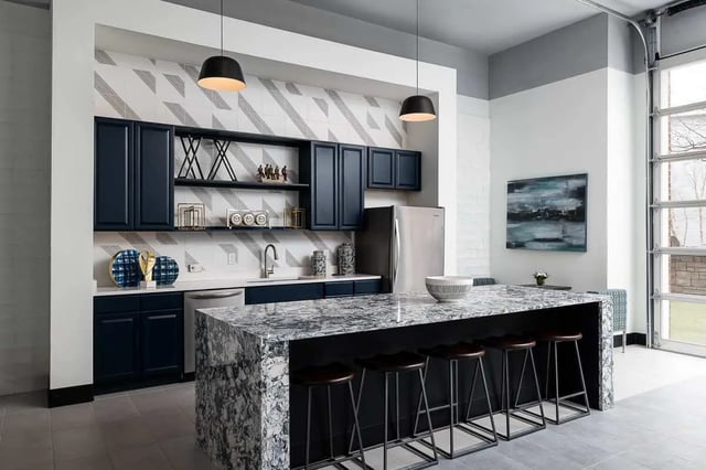 Dark cabinets marble island and stools kitchen at The Lex in Lexington Student Accommodation