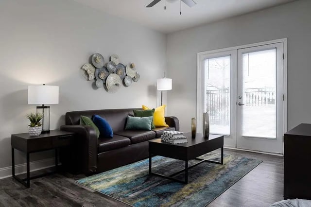 Sofa coffee table rug and decor living room at The Lex in Lexington Student Accommodation
