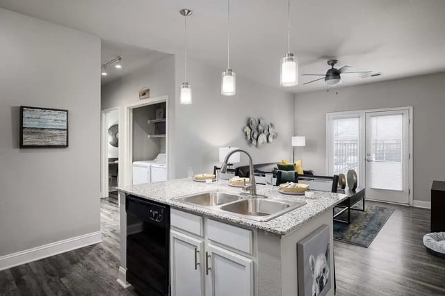 Kitchen island sink cabinets dishwasher living area exterior at The Lex in Lexington Student Accommodation