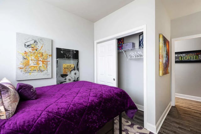 Purple bed artwork closet and doorway bedroom at The Lex in Lexington Student Accommodation