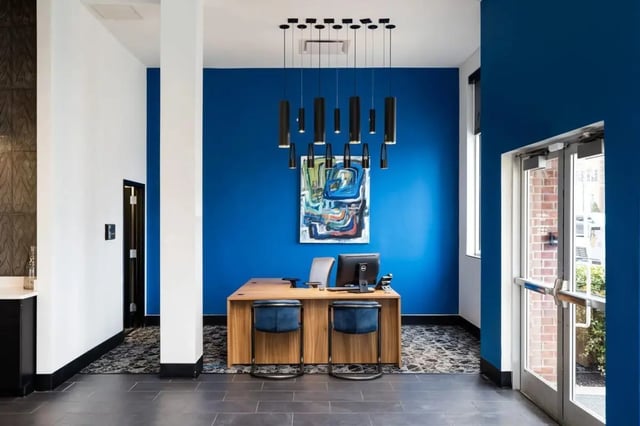 Reception desk with chairs modern art lobby at The Lex in Lexington Student Accommodation