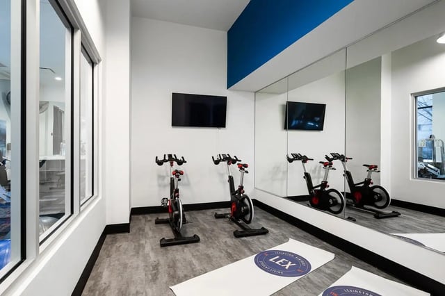 Exercise bikes and TVs gym area at The Lex in Lexington Student Accommodation