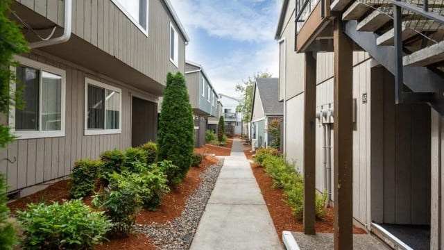 Buildings with pathway and green landscaping exterior at Connery Place Apartments in Portland Student Accommodation