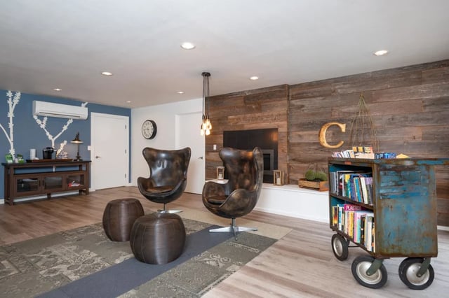 Two egg chairs with ottomans living room at Connery Place Apartments in Portland Student Accommodation