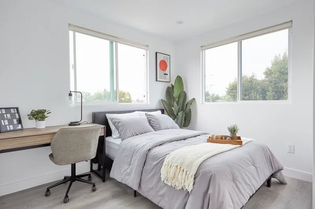 Bed desk chair plant art framed photos bedroom at 1360 W 35th St in Los Angeles Student Accommodation