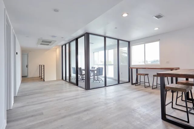 Glass enclosed meeting room and wooden tables Study area at 1360 W 35th St in Los Angeles Student Accommodation