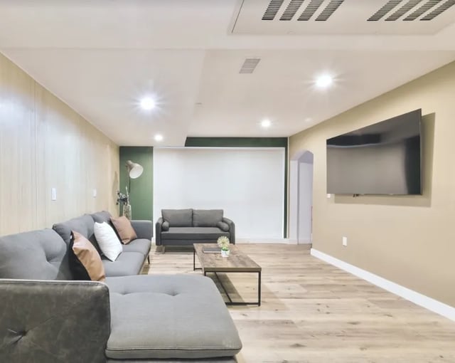 Gray sectional sofa coffee table television living room at 1360 W 35th St in Los Angeles Student Accommodation