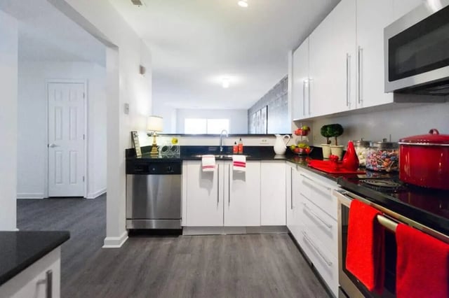 Modern white kitchen with stainless steel appliances kitchen at The Harrison in Harrisonburg Student Accommodation