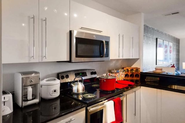 Modern kitchen with appliances cookware and cabinets Kitchen at The Harrison in Harrisonburg Student Accommodation
