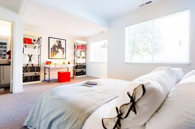 Bed with desk bookshelves and artwork bedroom at The Harrison in Harrisonburg Student Accommodation