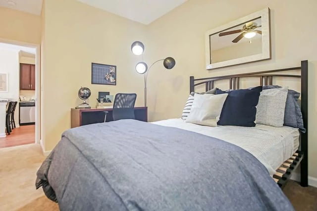Bed desk chair and floor lamp bedroom at West 22 in Kennesaw Student Accommodation