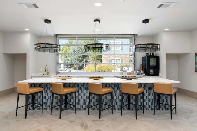 Bar with tan stools and large window kitchen area at West 22 in Kennesaw Student Accommodation