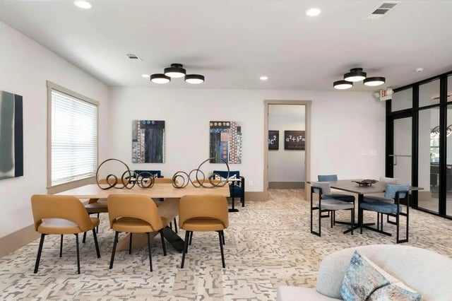 Dining table with chairs artwork and seating area living room at West 22 in Kennesaw Student Accommodation