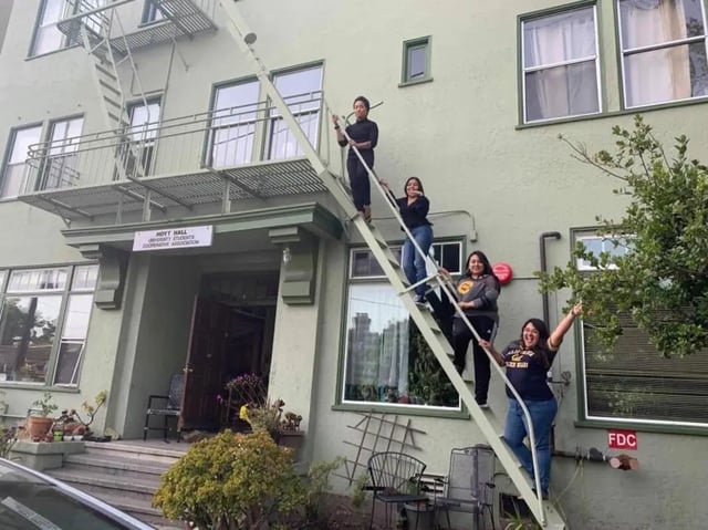 Four students on a fire escape exterior at Berkeley Student Cooperative - Affordable Student Housing Co-op in Berkeley Student Accommodation