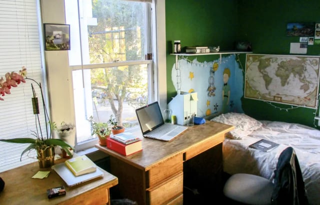 Desk with laptop plants bed and world map bedroom at Berkeley Student Cooperative - Affordable Student Housing Co-op in Berkeley Student Accommodation