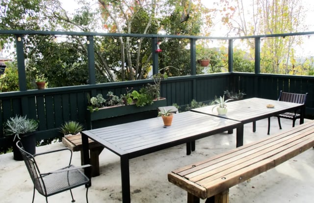 Patio tables and benches with plants exterior at Berkeley Student Cooperative - Affordable Student Housing Co-op in Berkeley Student Accommodation