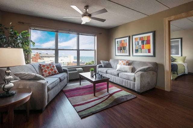 Two grey sofas coffee table colourful rug living room at 613 Maggie Frances in Madison Student Accommodation