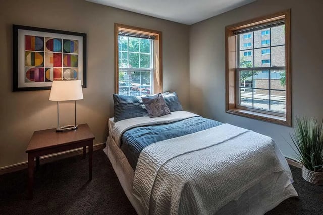 Bed with blue bedding and framed art Bedroom at 613 Maggie Frances in Madison Student Accommodation