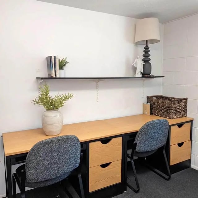 Two desks chairs lamp basket study area at Crestwood Rexburg Apartments in Rexburg Student Accommodation
