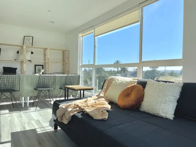 Sofa dining table chairs and shelves living room at 1476 W 35th St in Los Angeles Student Accommodation