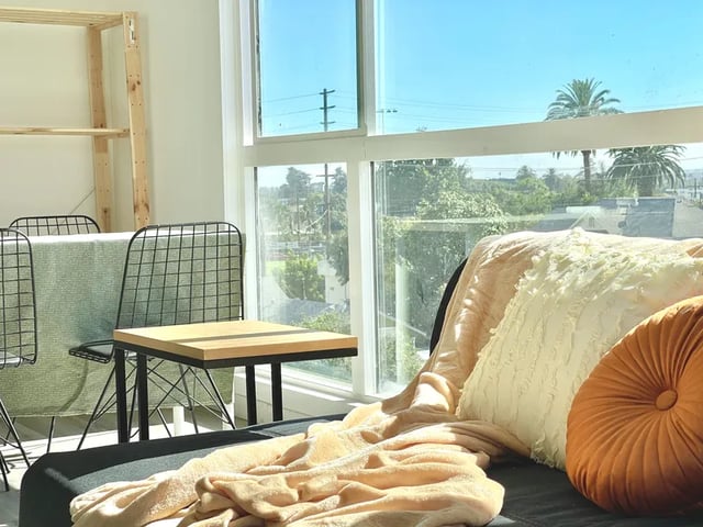 Chairs table blanket pillows living room at 1476 W 35th St in Los Angeles Student Accommodation