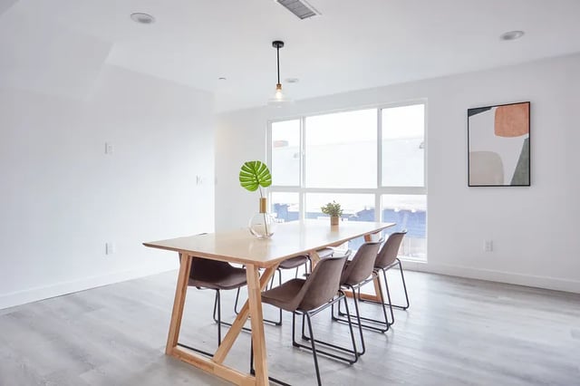 Wooden dining table with chairs and artwork dining area at 1476 W 35th St in Los Angeles Student Accommodation
