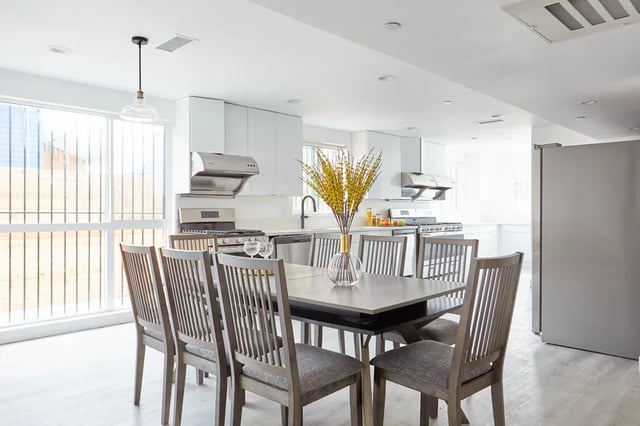 Dining table with chairs and kitchen view kitchen at 1476 W 35th St in Los Angeles Student Accommodation