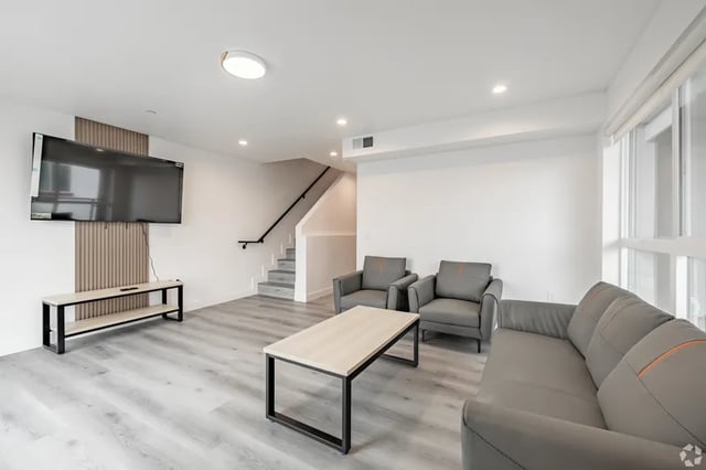 Sofa two chairs TV and coffee table living room at 1476 W 35th St in Los Angeles Student Accommodation