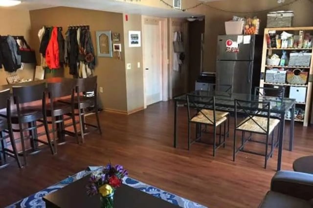 Bar chairs refrigerator dining table kitchen living room at 625 on Langdon in Madison Student Accommodation