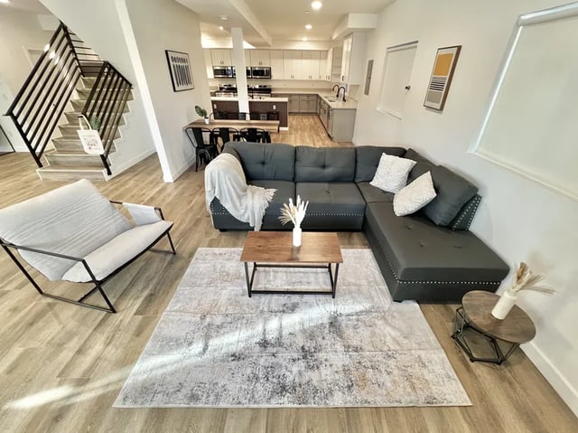 Sectional sofa coffee table armchair rug living room at 1587 W 35th St in Los Angeles Student Accommodation
