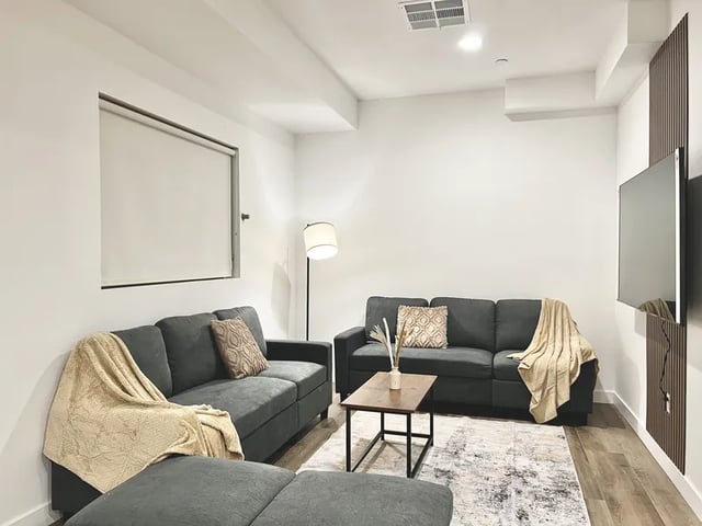 Two sofas coffee table TV and rug living room at 1587 W 35th St in Los Angeles Student Accommodation