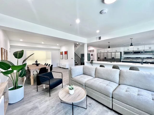 Sofa dining table kitchen and stairs living room at 1587 W 35th St in Los Angeles Student Accommodation