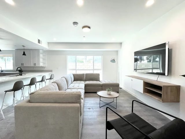 Sectional sofa tv stand and kitchen living room at 1587 W 35th St in Los Angeles Student Accommodation