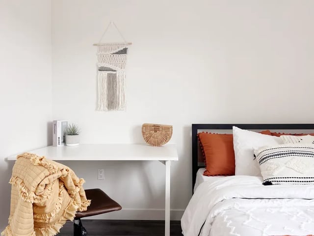 Desk, bed, pillows, macrame wall hanging bedroom at 1587 W 35th St in Los Angeles Student Accommodation