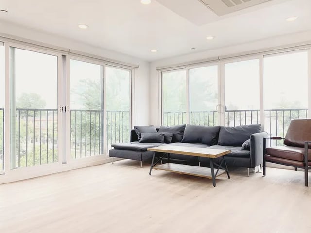 Dark sectional sofa coffee table brown armchair living room at 1587 W 35th St in Los Angeles Student Accommodation