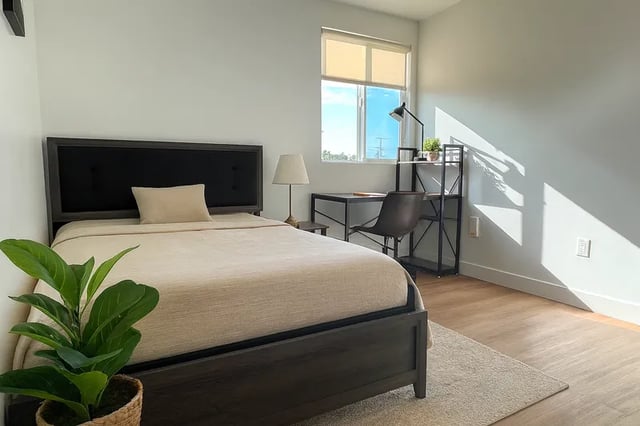 Bed desk lamp chair bookshelf bedroom at 1587 W 35th St in Los Angeles Student Accommodation
