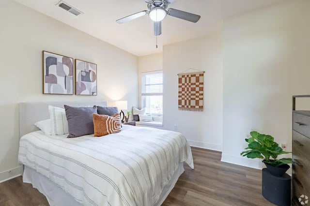 Bed with pillows and art Bedroom at 65 West in Cincinnati Student Accommodation