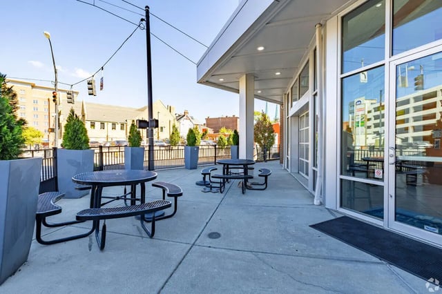 Outdoor tables and benches patio area at 65 West in Cincinnati Student Accommodation