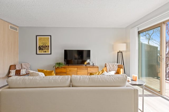 Sofa TV cabinet chairs and balcony living room at Mountainaire Boulder in Boulder Student Accommodation