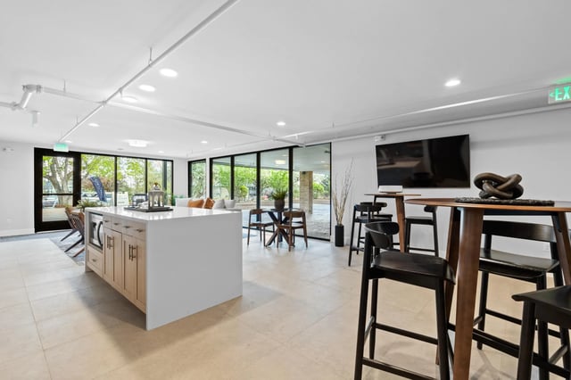 Kitchen island bar seating and large windows living area at Mountainaire Boulder in Boulder Student Accommodation