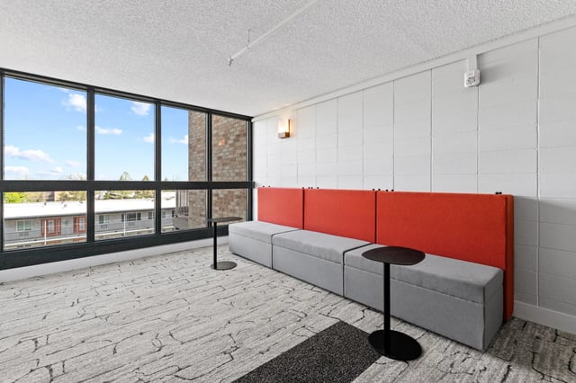 Gray modular sofa with orange backrests modern living area at Mountainaire Boulder in Boulder Student Accommodation