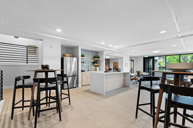 Kitchen island refrigerator chairs tables common area at Mountainaire Boulder in Boulder Student Accommodation