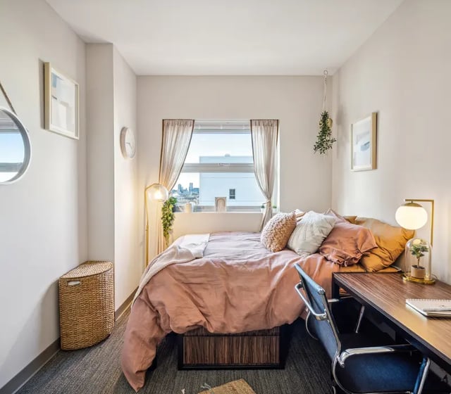 Bed desk chair and window Bedroom at The View at Montgomery in Philadelphia Student Accommodation