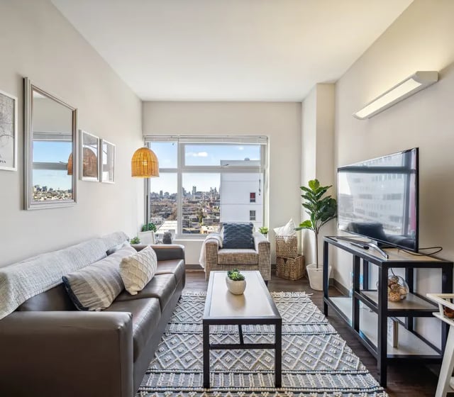 Sofa armchair coffee table TV living room at The View at Montgomery in Philadelphia Student Accommodation
