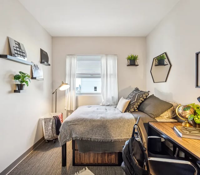 Bed desk plants and shelves bedroom at The View at Montgomery in Philadelphia Student Accommodation