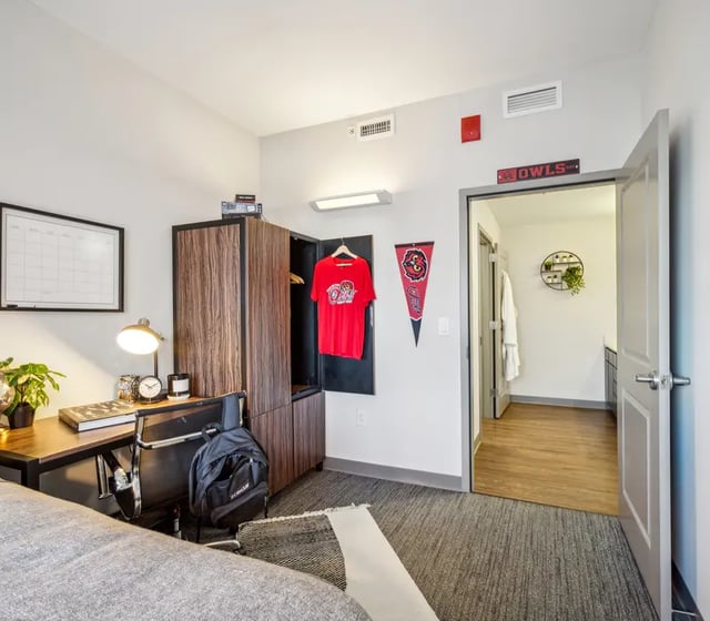 Desk chair wardrobe pennants and red shirt bedroom at The View at Montgomery in Philadelphia Student Accommodation