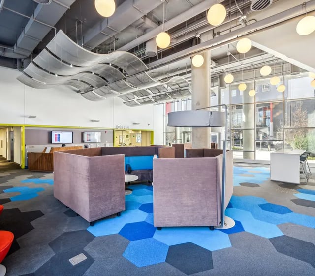 Office area with modular seating and hexagonal carpet. at The View at Montgomery in Philadelphia Student Accommodation