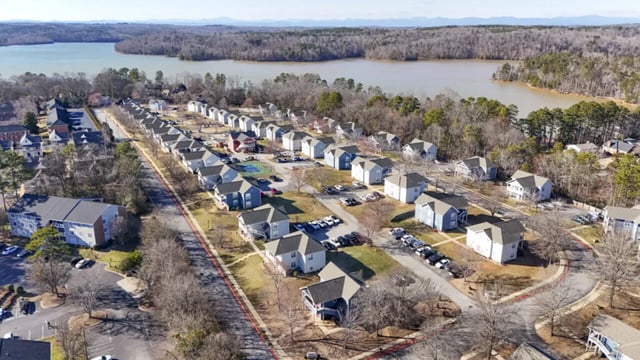Apartment buildings and houses lake exterior at Clemson Village in Clemson Student Accommodation