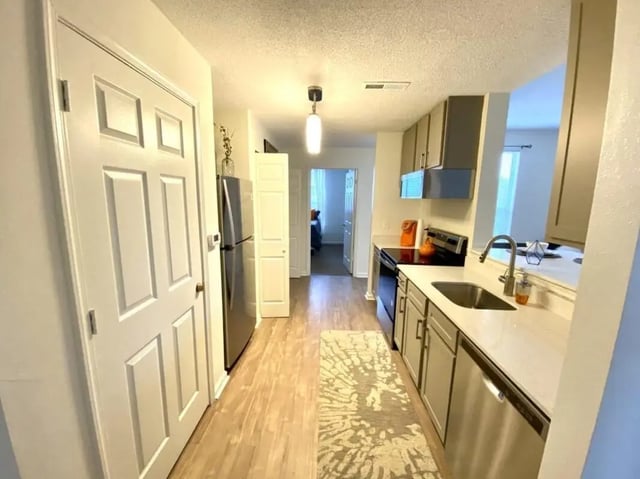 White doors refrigerator sink cabinets stove kitchen at Clemson Village in Clemson Student Accommodation